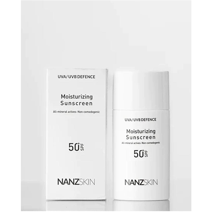 This image displays the NANZSKIN Uva/uvb Defence Moisturizing Sunscreen, presented in a sleek, modern packaging. The product, offered in a 50 ml container, is designed to provide broad-spectrum SPF 50 protection, safeguarding against UVA and UVB rays as well as infrared radiation, blue light, and pollution.